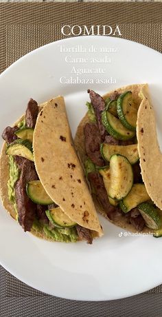 two tacos on a plate with cucumbers and meat