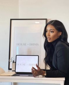 a woman sitting at a desk with a laptop computer in front of her and the words house of bras on it