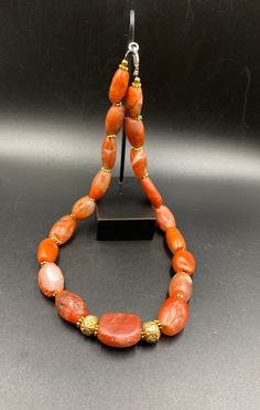 The Rare Unique PEMA RAKA Carnelian Amulet Prayer Beads Necklace From Himalayan Tibet The Age Of This Beads Are More than 1000 years Old As You Can See From Its Conditions Very Oily Smooth Skin Of This Pema Beads Some Gold Plated Wax and Gold Color Brass Beads Are Used As Spacers Rare Items For Collections Traditional Hand-strung Agate Jewelry, Orange Amulet-style Jewelry With Large Beads, Orange Agate Oval Beads Jewelry, Orange Agate Oval Beaded Jewelry, Hand-strung Agate Jewelry With Oval Beads, Hand-strung Oval Agate Bead Jewelry, Traditional Orange Gemstone Jewelry, Spiritual Orange Jewelry With Oval Beads, Traditional Carnelian Gemstone Beads