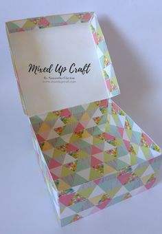 the inside of a small box that is made up of colorful triangles and has a card in it