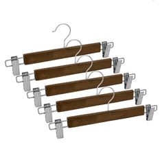 four wooden clothes hangers with metal clips on each side and two hooks attached to them