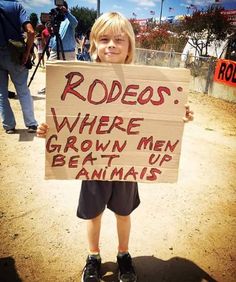 a little boy holding a sign that says rodeos where grown men beat up animals