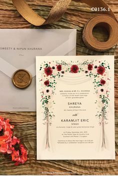 the wedding stationery is laid out on top of a table with flowers and ribbon