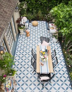 an aerial view of a patio with table and chairs, potted plants and trees