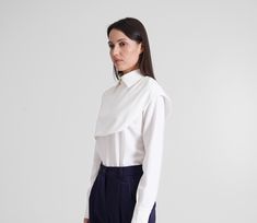 White collared blouse with long sleeves. - high neckline - long sleeves with cuffs - semi-fitted silhouette  - concealed back zipper closure - asymmetrical detail Color: beige / milky white/ black / navy Fabric - viscose - 30, polyester - 65%, elastane - 5%. For Size 2 US / 36 EU: length - 21,5" (55 cm) Our model wears a 2 US size and is 168cm/5'6" tall MORE ITEMS: https://www.etsy.com/shop/TAVROVSKA?ref=hdr_shop_menu Modern Office Wear Blouse With Button Cuffs, Modern Blouse With Button Cuffs For Office Wear, Modern Long Sleeve Tops With Cuffed Sleeves, Modern Collared Blouse For Office Wear, Long Sleeve Work Shirt With Button Cuffs, Long Sleeve Shirt With Button Cuffs For Work, Modern Collared Formal Blouse, Modern Formal Collared Blouse, Modern Business Casual Blouse For Fall