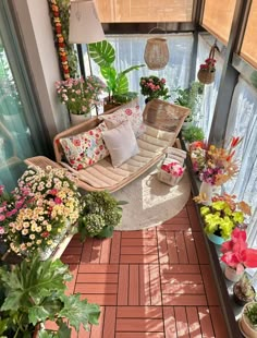 a room filled with lots of plants and flowers on top of it's windowsill