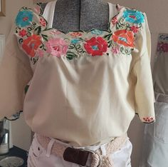 This is a beautiful, embroiderd top made I'm Mexico, slightly slim cut, embroidered all around the edges and sleeves, it's a cream(off-white) color and the embroidery is pastels. Cream Cotton Top With Floral Embroidery, Spring Cream Embroidered Top, Classic Cream Embroidered Top, Spring Cream Embroidered Long Sleeve Top, Vintage Cream Embroidered Tops, Womens Blouses, Off White Color, Embroidered Top, White Color