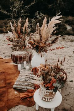 two vases filled with flowers sitting on top of a table