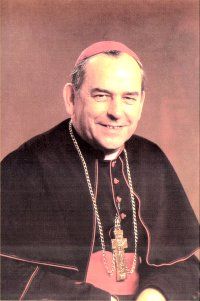 a man in a priest's outfit smiling at the camera