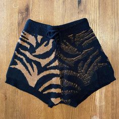 Soft Knit Dual Tone Tiger Print Shorts With Adjustable Waist Casual Black Knit Bottoms, Black Knit Bottoms For Loungewear, Cozy Black Bottoms For Fall, Black Knit Bottoms For Spring, Brown Bottoms For Fall Vacation, One Size Black Bottoms For Fall, Black Casual Bottoms, One Size, Tiger Shorts, Knitted Shorts