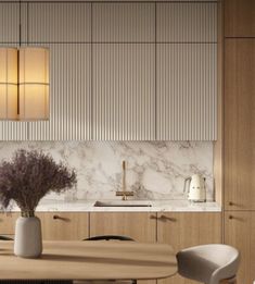 a modern kitchen with marble counter tops and wooden cabinetry, along with an oval dining table