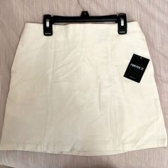 Off-White Mini Skirt From Forever 21 Never Been Worn Tags Still Attached, Size Medium. Chic Forever 21 Cotton Skirt, White Pencil Skirt Skort For Summer, White Pencil Mini Skirt For Day Out, Forever 21 White Cotton Mini Skirt, Forever 21 White Summer Skirt, Chic Cotton Mini Skirt By Forever 21, Chic White Forever 21 Skirt, Forever 21 Fitted White Mini Skirt, Forever 21 Summer Pencil Mini Skirt