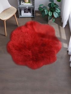 a red rug is on the floor next to a chair