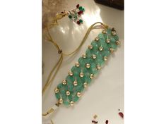 "Elevate your bridal look with this exquisite gold-tone Kundan choker set, featuring vibrant green beads and a designer floral pattern. Perfect for weddings, this Polki Kundan jewelry blends tradition with elegance. Polki Kundan, Kundan Polki, Polki necklace, Kundan set, bridal jewelry set, Polki choker necklace, Kundan Polki jewellery." Necklace and Earrings Necklace Has Been Adjustable Cord Push Back Earrings Length Of Earrings - 1.25 Inches Gold Tone , Kundan , Stone , Bead *SHOP LINK - https Green Kundan Necklace For Reception And Festivals, Festive Green Choker For Wedding, Green Wedding Choker For Festive Occasions, Green Kundan Necklace For Receptions And Festivals, Green Tilla Bridal Necklace For Reception, Traditional Green Choker For Reception, Green Kundan Necklace With Cutdana For Reception, Green Choker For Diwali Party, Green Bridal Choker For Festive Occasion