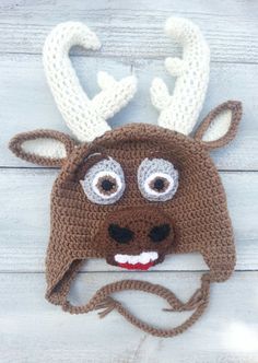 a crocheted deer hat with antlers on it's ears and nose