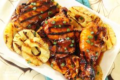 grilled chicken and pineapples on a white plate