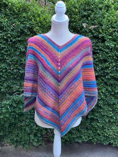 This poncho has gorgeous colors!! Crocheted with very soft acrylic yarn When laying flat measures approx:       point to point at arms  51"       point at neck to bottom point  22" Would look awesome with jeans and boots as well as over a dress! Poncho Au Crochet, Ladies Poncho, Crochet Poncho, La Pointe, Ponchos, Acrylic Yarn, Jeans And Boots, Bathing Beauties, Yarn