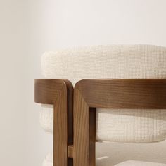 a close up view of the back of a chair with wood frame and fabric on it