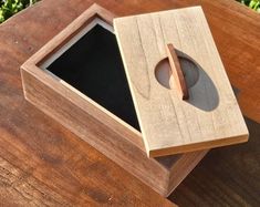 a wooden box sitting on top of a wooden table