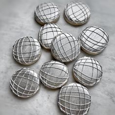 six cookies that have been decorated with silver wire on top of each other and are sitting on a table