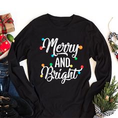 Classic Fit Festive Christmas Long Sleeve Shirts for Women - Merry and Bright, Cute Holiday Gift, Unisex Xmas T-Shirt. 8 Oz./Yd² (Us) 13.3 Oz./L Yd (CA), 50/50 Preshrunk Cotton/Polyester Heather Sport Colors: 60/40 Polyester/Cotton Safety Green: Compliant With ANSI / ISEA 107 Air Jet Yarn for Softer Feel and Reduced Pilling Double-needle stitching at Shoulders, Armholes, Neck, Waistband, and Cuffs 1x1 Rib With Spandex for Enhanced Stretch and Recovery Merry and Bright Christmas Shirt Grey Pearlized Tear Away Label Christmas Long Sleeve T-Shirt, Merry and Bright Unisex Long Sleeve Shirt, Christmas Holiday Shirt, Xmas Festive Gift Shirt. High-Quality Air Jet Yarn for Softer Feel and Reduced Pilling. Double-Needle Stitching at Shoulders, Armholes, Neck, Waistband, and Cuffs. Crafted with care Black Long Sleeve Christmas T-shirt, Festive Winter Shirt With Letter Print, Black Shirt For Winter Holiday, Black Long Sleeve Christmas Shirt, Christmas Festive Tops With Letter Print, Festive Long Sleeve T-shirt For Holiday, Festive Long Sleeve Holiday T-shirt, Festive Christmas Letter Print Tops, Festive Winter Crew Neck Shirt