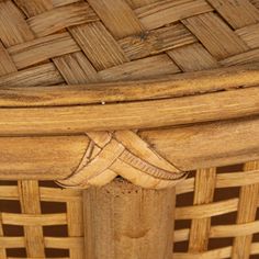 a close up of a wooden chair with woven seat