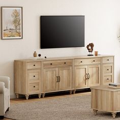 a living room with furniture and a flat screen tv mounted on the wall above it