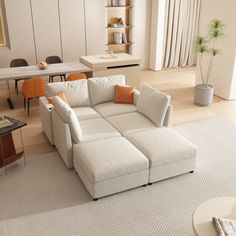 a living room filled with furniture and a white rug on top of a hard wood floor