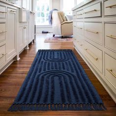 a large blue rug in the middle of a kitchen