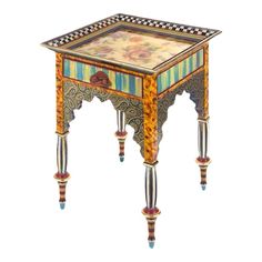 an ornately decorated side table with glass top