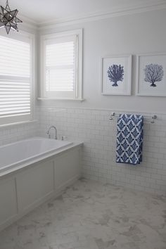 a white bathroom with blue and white decor