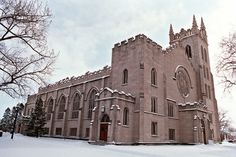 an old church with snow on the ground