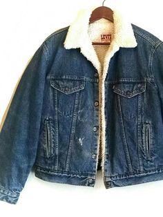 "Vintage Levi's denim faux Sherpa jean jacket. The perfect hip yet practical jean jacket. 1970's -1980's white and red label denim jacket, classic silhouette with soft warm plush lining. This item is in very good vintage condition. Soft spots and areas of distress. * Size: 42 Regular * Shell: 100% Cotton * Lining: 100% Polyester * Sleeve Lining: 100% Nylon Batting bonded polyester * Brand: Levi's San Francisco Measurements taken while garment is lying flat. * Chest: 22\" * Length: 24\"" Vintage Denim Outerwear For Winter, Vintage Winter Denim Outerwear, Vintage Winter Outerwear In Medium Wash, Retro Denim Winter Outerwear, Vintage Denim Jacket Medium Wash For Winter, Vintage Winter Denim Jacket In Medium Wash, Retro Denim Blue Jacket For Winter, Retro Relaxed Fit Denim Jacket For Winter, Retro Medium Wash Winter Outerwear