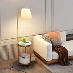 a living room with a couch, table and lamp on the floor next to it