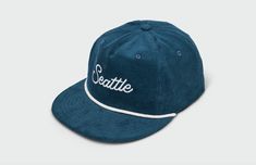 This Seattle Script 5 Panel Hat features quality cotton corduroy and rope detailing. The hip vintage flatbill design keeps the sun out of eyes, and the adjustable snapback closure ensures a personalized, comfortable fit. This hat is perfect for any fan of the Emerald City. 100% Cotton Corduroy Cap Matching Corduroy UnderVisor Vintage Lightly Structured Fit Snapback Closure Medium Crown One Size Fits Most Adults (6 7/8 to 7 3/4) Made in the USACut and Sewn in Kansas City, MO Adjustable Corduroy Trucker Hat With Flat Brim, Retro Adjustable Cotton Trucker Hat, Adjustable Cotton Snapback Trucker Hat, Casual Corduroy Snapback Baseball Cap, Corduroy Snapback Hat For Streetwear, Trendy Corduroy Snapback Baseball Cap, Everyday Corduroy Snapback Baseball Cap, Adjustable Corduroy Snapback Cap, Adjustable Corduroy Snapback Hat