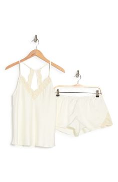 Perfect for romantic evenings, this elegant pajama set crafted in smooth matte satin includes a lace-trimmed racerback camisole and matching shorts. 2-piece set Top has V-neck; adjustable straps; open racerback; scalloped lace trim; satin construction Shorts have elastic waist; scalloped lace trim; satin construction 100% polyester Hand wash, dry flat Imported Model stats: 5'10" height, 32" bust, 25" waist, 36" hip. Model is wearing size S. Feminine Sleeveless Sleep Sets, Elegant Night Sets For Summer, Elegant Summer Night Sets, Elegant Bedtime Sets For Spring, Chic Sleepwear With Lace Trim For Loungewear, Feminine Cami Sleepwear For Night, Elegant Cami Sleepwear For Loungewear, Elegant Camisole Sleep Sets, Elegant Sleep Sets With Camisole