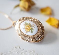 Yellow Rose Gold Oval Photo Locket. A lovely 30mm x23mm oval locket is adorned with a beautiful vintage Japanese floral porcelain cabochon (18mmx13mm) with yellow rose design. The locket is in gold finish with beautiful etched design on both front and back. The locket can open to hold two photos or small treasures. PERSONALISATION We can personalize this locket by adding 1 or 2 photos for you. You can also choose to add photo (s) on your own. Please choose the options from drop-down menu. How to Butterfly Locket Necklace, Rose Locket, Gold Locket Necklace, Add Photo, Photo Locket Necklace, Oval Locket, Heart Locket Necklace, 1 Rose, Family Jewellery