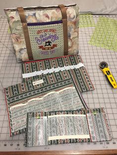 sewing supplies laid out on a cutting board with scissors and rulers next to them