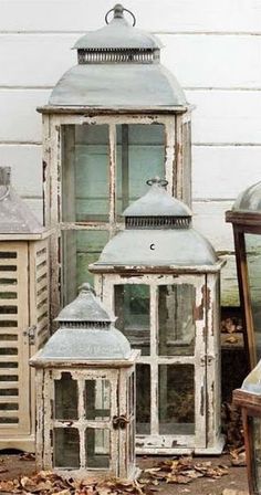 three white lanterns sitting next to each other