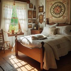 a bed sitting in a bedroom next to a window with sun shining through the curtains