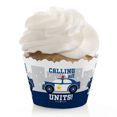 a cupcake with white frosting and a police car on it's wrapper