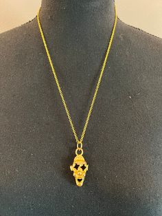 A unique gold-colored "skull" pendant, one of a kind. Unique Gold Necklaces With Charms, One-of-a-kind Gold Brass Necklaces, Gold Hand Cast Amulet Jewelry, Yellow Gold Skull Jewelry For Gift, Hand Cast Gold Metal Necklace, Hand Cast Gold Necklace In Metal, Gold Skull Jewelry Collectible, Gold Skull Collectible Jewelry, Gold Skull Jewelry For Collectors