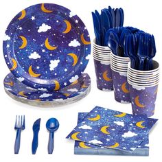 a set of blue and yellow dinnerware with stars and moon designs on it, including forks, knives, napkins, and spoons