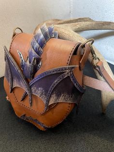 a leather bat shaped object sitting on top of a table