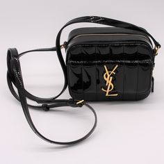 This Listing Is For A Gorgeous Purse From Ysl This Is In Brand New Condition And Comes With Authenticity Cards And A Dust Bag. This Black Saint Laurent Vicky Mini Patent Leather Camera Bag Has Been Designed With Exacting Detail In Italy. Handcrafted From Patent Leather, This Style Has A Fold-Over Front Fastening, Magnetic Closure, Internal Slip Pocket, Front Logo Plaque, A Quilted Effect, Two-Way Zip Fastening And Adjustable Shoulder Strap. We’d Like To Think The Saint Laurent Vicky Mini Patent Saint Laurent Vinyle Round Camera Bag, Ysl College Bag, Ysl Camera Bag, Ysl Lou Camera Bag, Ysl Kate, Saint Laurent Purse, Girls Shoes Sneakers, Leather Camera Bag, Yves Saint Laurent Bags