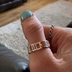 a woman's hand with a ring on it