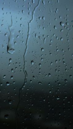 raindrops on the window with blue sky in background