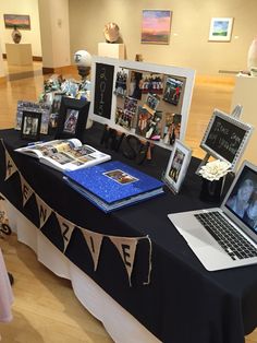 a table topped with pictures and laptop computers