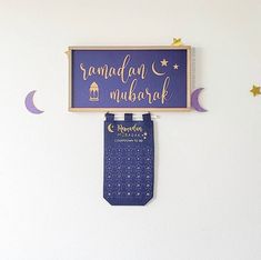 there is a sign that says ramadan mubarak hanging on the wall above it