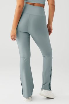 Everything you love about forward flares, now in a sleek new silhouette! The High-Waist 7/8 Game Changer Legging in performance-perfect Airlift is ready for studio days and nights out, with Alo’s signature high rise and secure wide waistband. A flared leg with side snap closure adds extra ventilation and is great for showing sneakers! Effortlessly tie this look together by pairing it with a cropped coverup. Smoothing, second skin feel & cool side snaps Forward bootcut fit & wide waistband Design Alo Yoga 4-way Stretch Athleisure Bottoms, Alo Yoga Compression Bottoms For Pilates, Alo Yoga Athleisure Bottoms For Pilates, Alo Yoga Elastane 4-way Stretch Bottoms, Alo Yoga Elastane Bottoms With 4-way Stretch, Fitted Flare Activewear For Athleisure, Fitted Flare Athleisure Activewear, Alo Yoga 4-way Stretch Bottoms, High Stretch Flare Activewear For Pilates